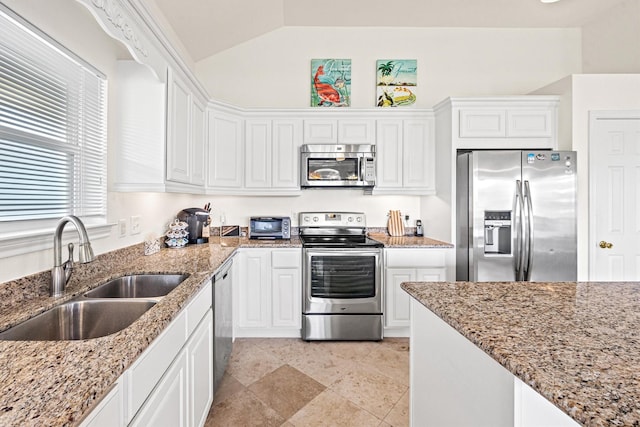 kitchen with sink, white cabinets, stainless steel appliances, and lofted ceiling