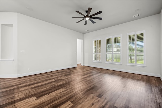 spare room featuring ceiling fan and dark wood-type flooring