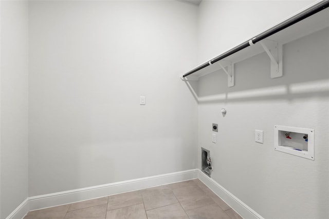 clothes washing area featuring gas dryer hookup, light tile patterned floors, washer hookup, and hookup for an electric dryer