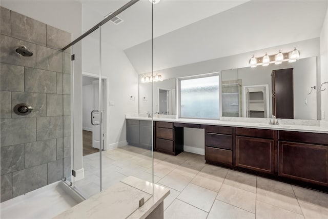 bathroom featuring tile patterned floors, a shower with shower door, lofted ceiling, and vanity