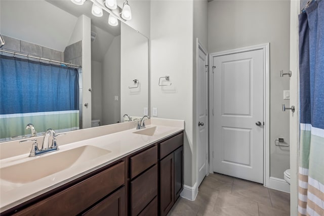 bathroom with a shower with curtain, tile patterned flooring, vanity, and toilet