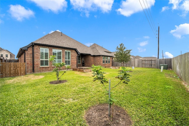 back of house featuring a yard