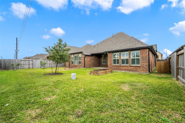 rear view of property featuring a yard