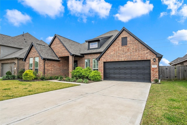 view of front of home featuring a front yard and a garage