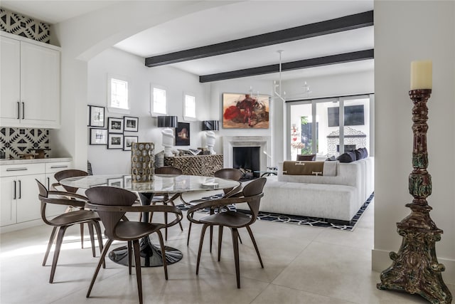 dining area featuring beam ceiling