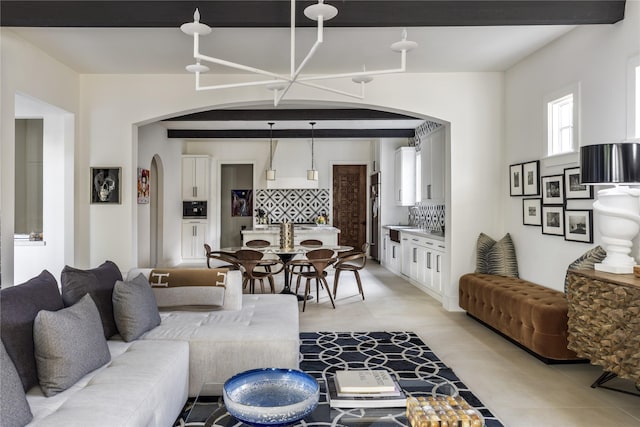 living room featuring beam ceiling and light tile patterned floors