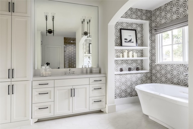 bathroom featuring tile patterned flooring, shower with separate bathtub, vanity, and tile walls