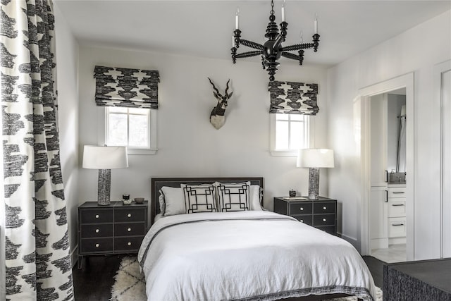 bedroom with dark hardwood / wood-style floors, multiple windows, and ensuite bath