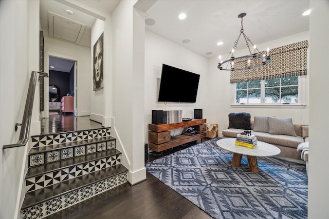 living room with dark hardwood / wood-style floors and an inviting chandelier