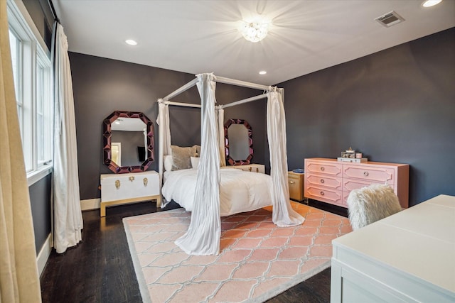 bedroom with wood-type flooring and multiple windows