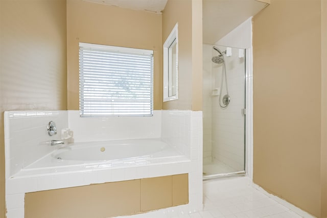 bathroom featuring tile patterned flooring and shower with separate bathtub