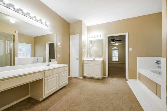 bathroom with ceiling fan, a bath, and vanity