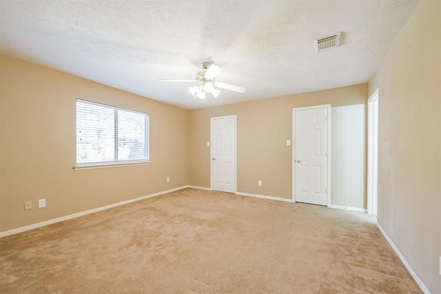 carpeted empty room with a textured ceiling and ceiling fan