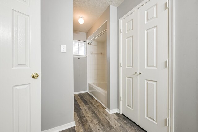 mudroom featuring dark hardwood / wood-style floors and a textured ceiling