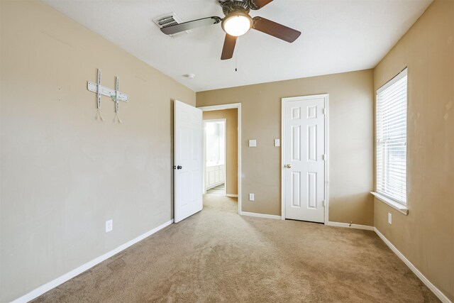 unfurnished bedroom with ceiling fan and light carpet