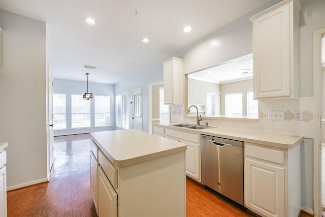 kitchen with a center island, stainless steel dishwasher, plenty of natural light, and sink