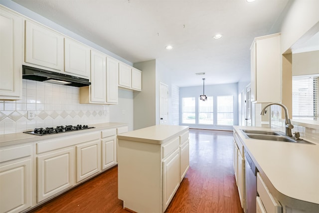 kitchen featuring pendant lighting, a center island, a healthy amount of sunlight, and appliances with stainless steel finishes