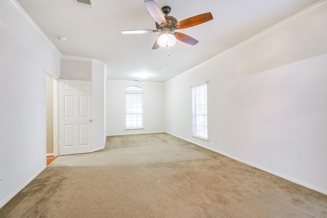 carpeted empty room with ceiling fan and crown molding