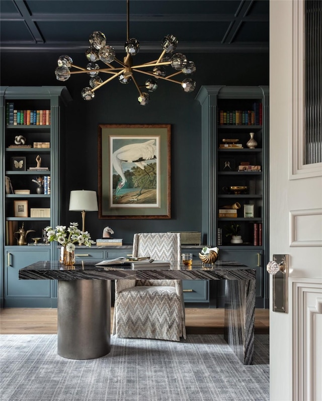 living area featuring built in shelves and an inviting chandelier