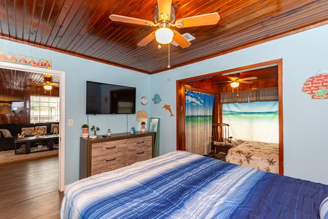 bedroom with wooden ceiling, dark hardwood / wood-style floors, ceiling fan, and crown molding