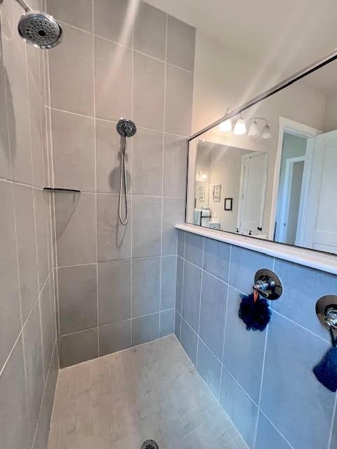 bathroom with a tile shower