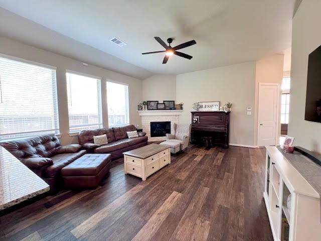 living room featuring ceiling fan and dark wood-type flooring