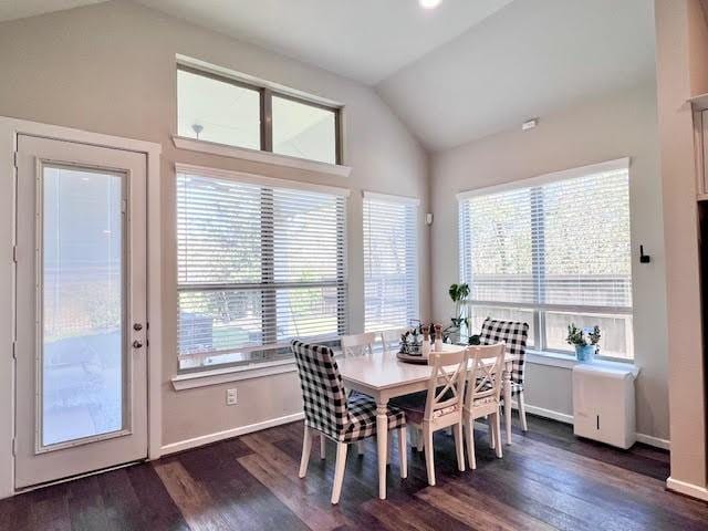 dining room featuring dark hardwood / wood-style floors and lofted ceiling