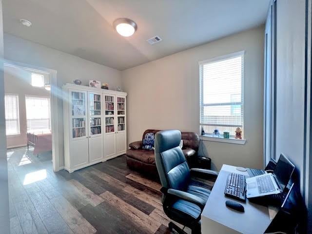 office area with dark hardwood / wood-style floors and a wealth of natural light