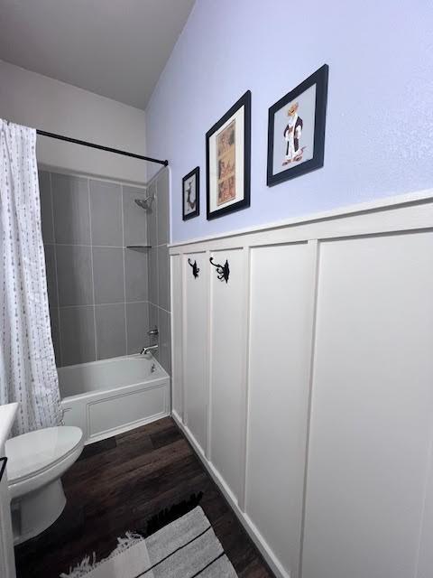 full bathroom featuring toilet, vanity, hardwood / wood-style flooring, and shower / tub combo with curtain