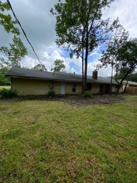 view of side of home featuring a lawn