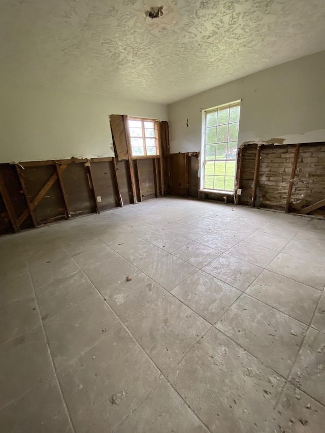 spare room with a textured ceiling