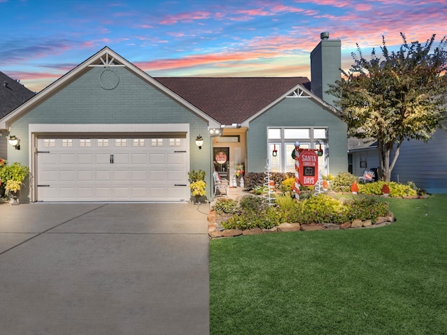 view of front of home featuring a yard and a garage