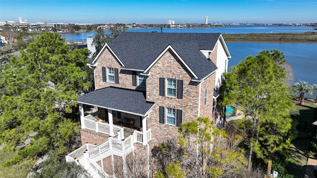 view of front of house with covered porch and a water view