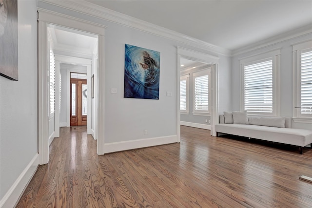 unfurnished room with hardwood / wood-style flooring and crown molding