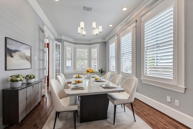 dining room featuring a chandelier, dark hardwood / wood-style flooring, and ornamental molding