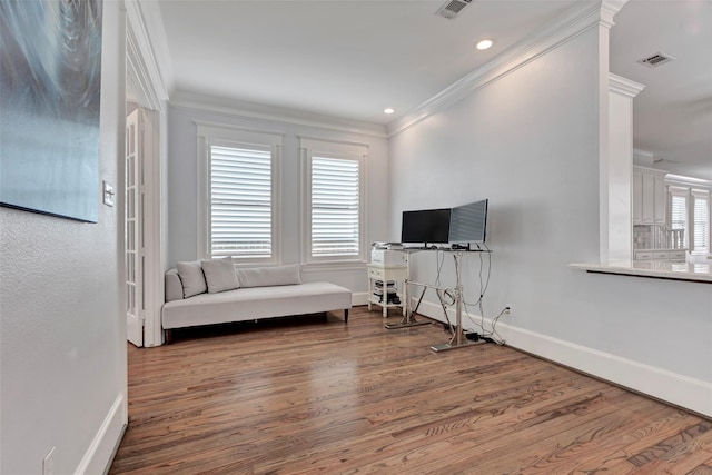 sitting room with hardwood / wood-style flooring and ornamental molding