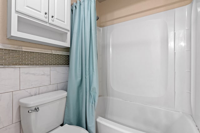 bathroom with shower / bath combination with curtain, toilet, and tile walls