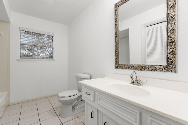 bathroom featuring tile patterned floors, vanity, toilet, and a bath