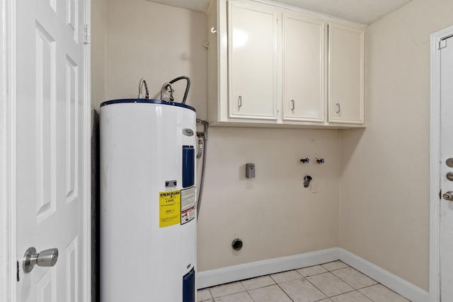 washroom with electric dryer hookup, cabinets, electric water heater, and light tile patterned floors