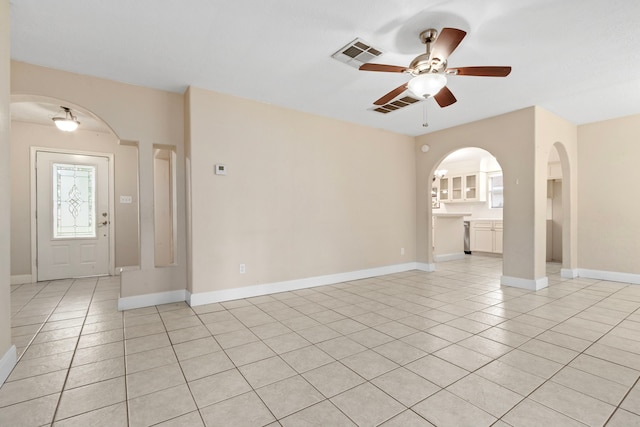 tiled spare room with ceiling fan