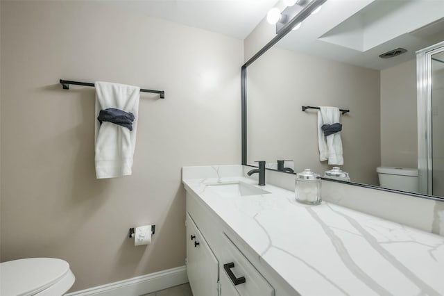 bathroom featuring toilet, visible vents, vanity, and baseboards