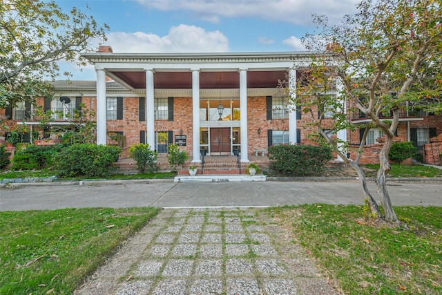 greek revival house featuring brick siding