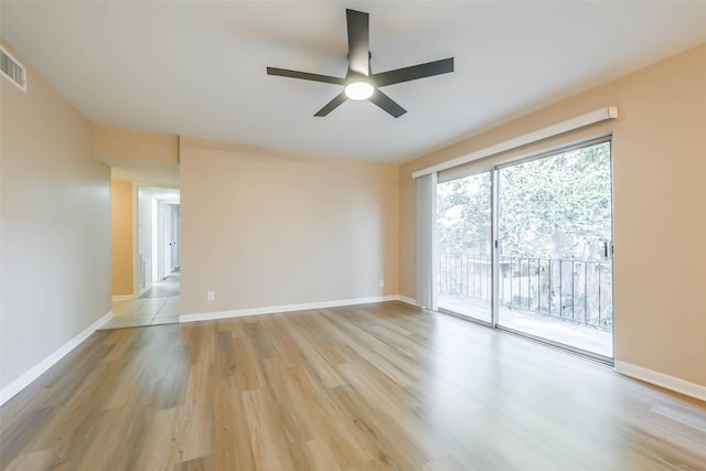 unfurnished room featuring ceiling fan, light wood-style flooring, and baseboards