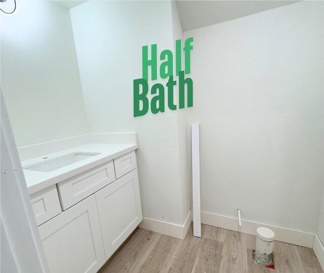 bathroom with vanity and hardwood / wood-style floors