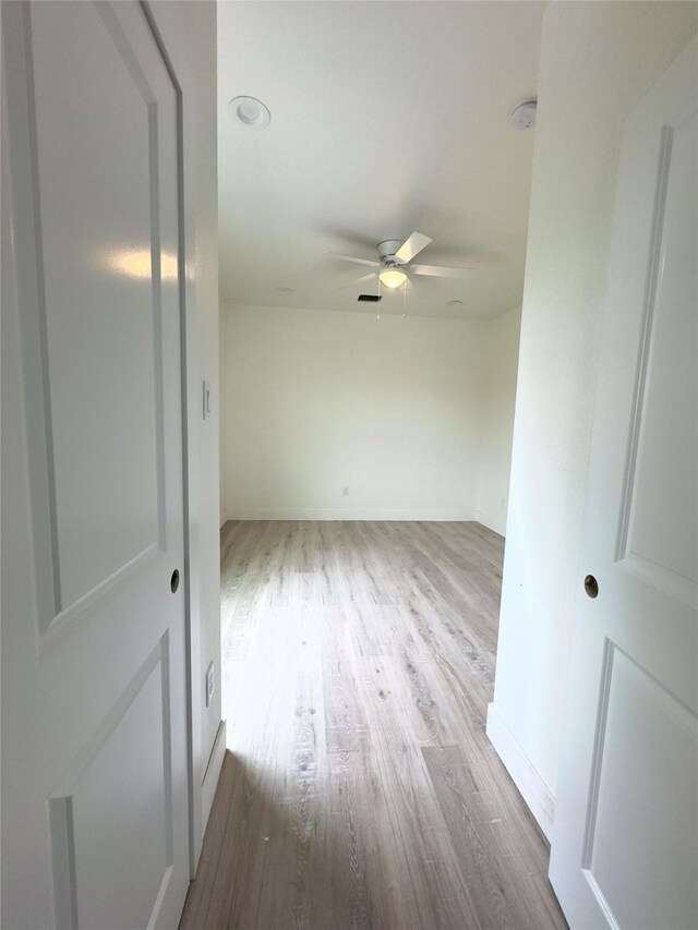 unfurnished room featuring ceiling fan and light wood-type flooring