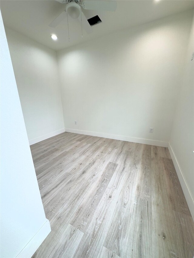 unfurnished room with ceiling fan and light wood-type flooring