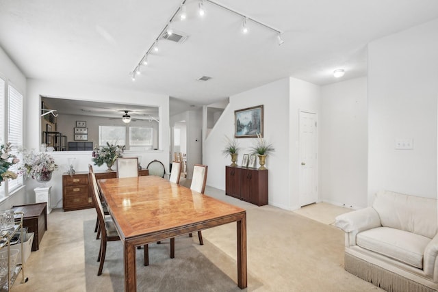 carpeted dining space featuring a healthy amount of sunlight and ceiling fan