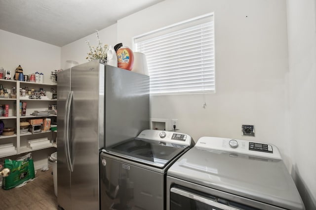 laundry room featuring separate washer and dryer and hardwood / wood-style floors