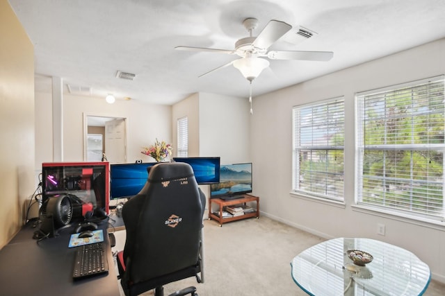 office space with light carpet and ceiling fan