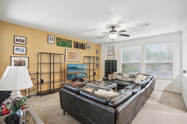 living room with ceiling fan and light colored carpet